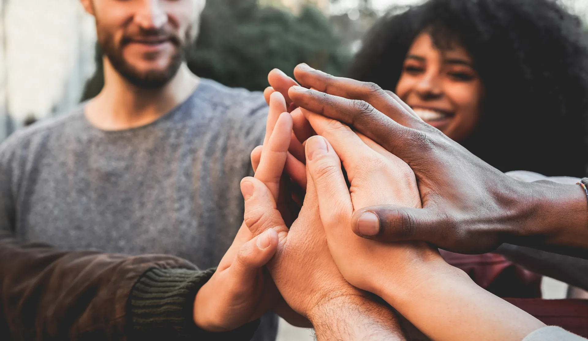 Hands joined in a group — real people coming together